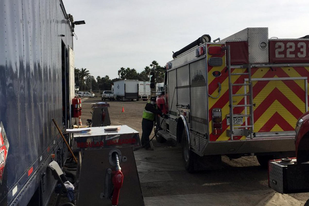 Fueling up fire trucks with our mobile fueling truck, in heavy smoke and heat conditions